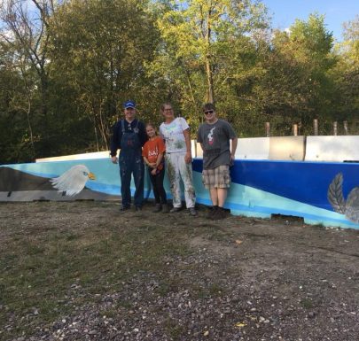 Four individuals standing for a group picture