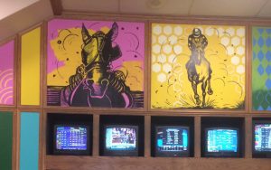 Pink and yellow wall paintings of horses