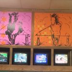 Pink and orange wall paintings of horses