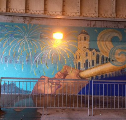 A mural painted on the side of a bridge.