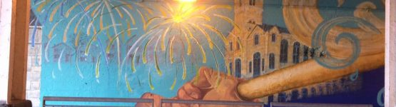 A mural painted on the side of a bridge.