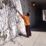A woman cleaning a wall