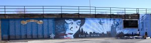 A blue woman and red teardrop wall painting