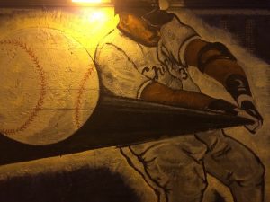 A baseball player painting on a wall