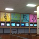 Wall paintings behind digital screens