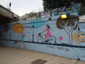 A woman cycling wall painting