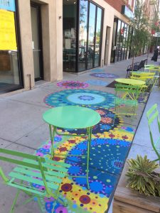 Colorful mandalas on the ground with colorful chair