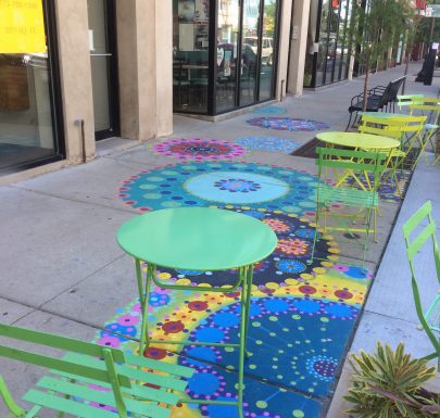 Colorful mandalas on the ground with colorful chair