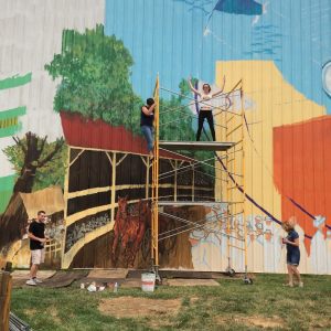 People painting a big wall painting