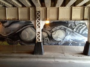 A wall painting of hands and balls