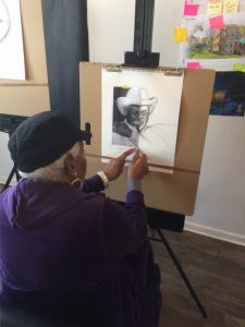 An old woman sketching