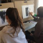 Two girls sketching