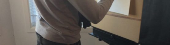 A boy sketching with a canvas stand