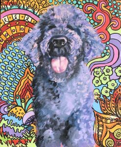 A dog painting in front of a colorful design