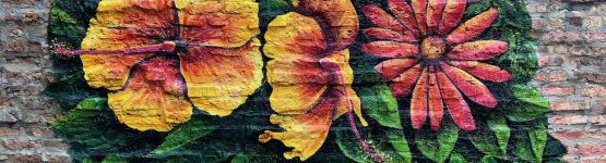 A colorful mural painted on the side of a brick wall.