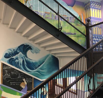 A colorful staircase with a mural on it.