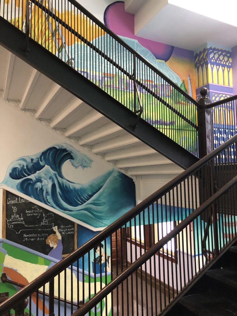 A colorful staircase with a mural on it.