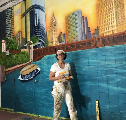 A woman painting a lake on the wall