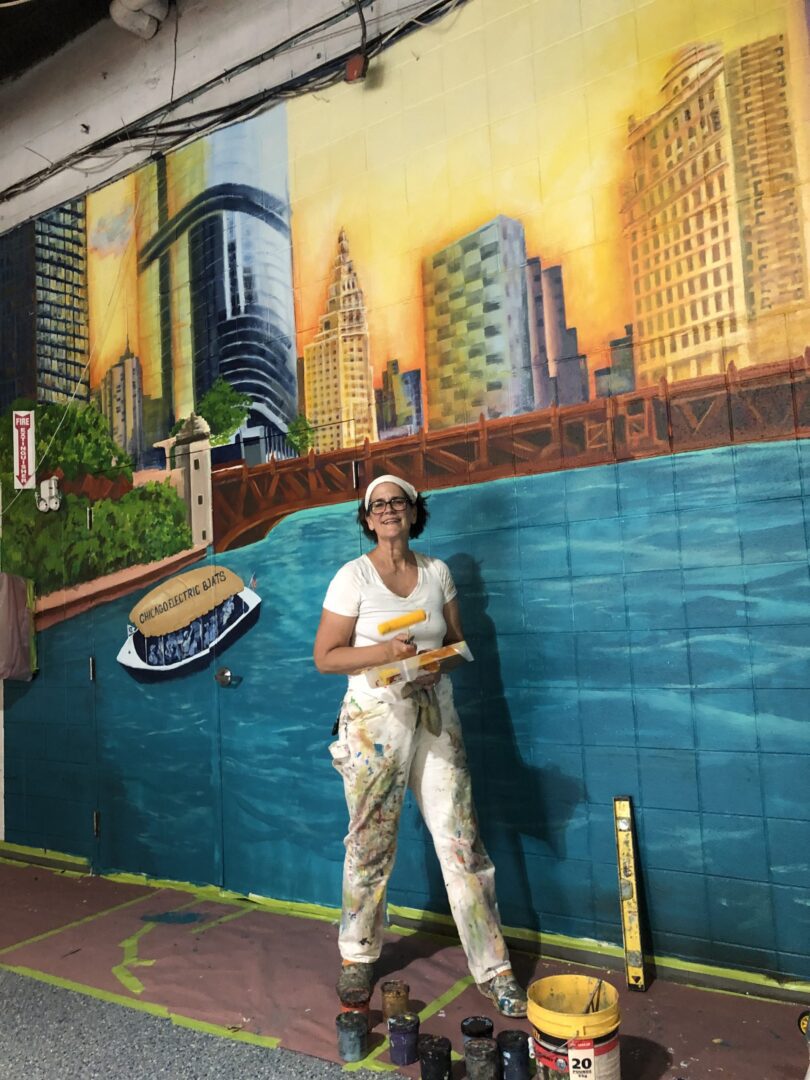 A woman painting a lake on the wall