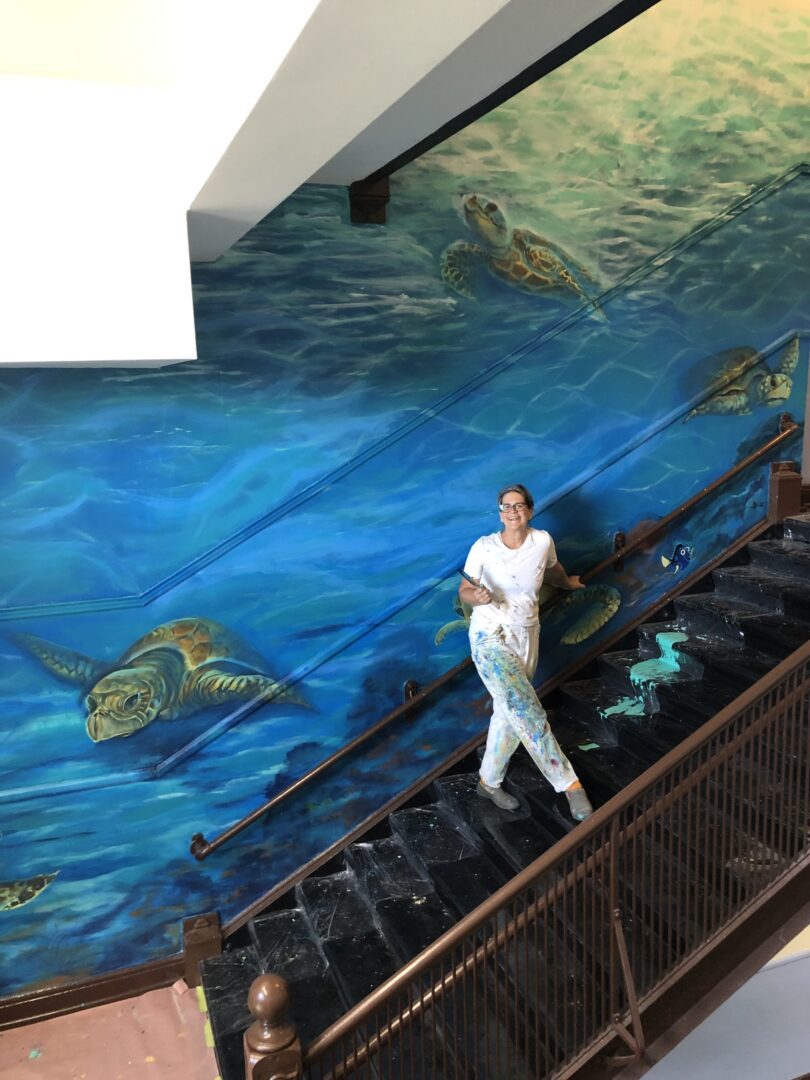 A woman painting a staircase wall