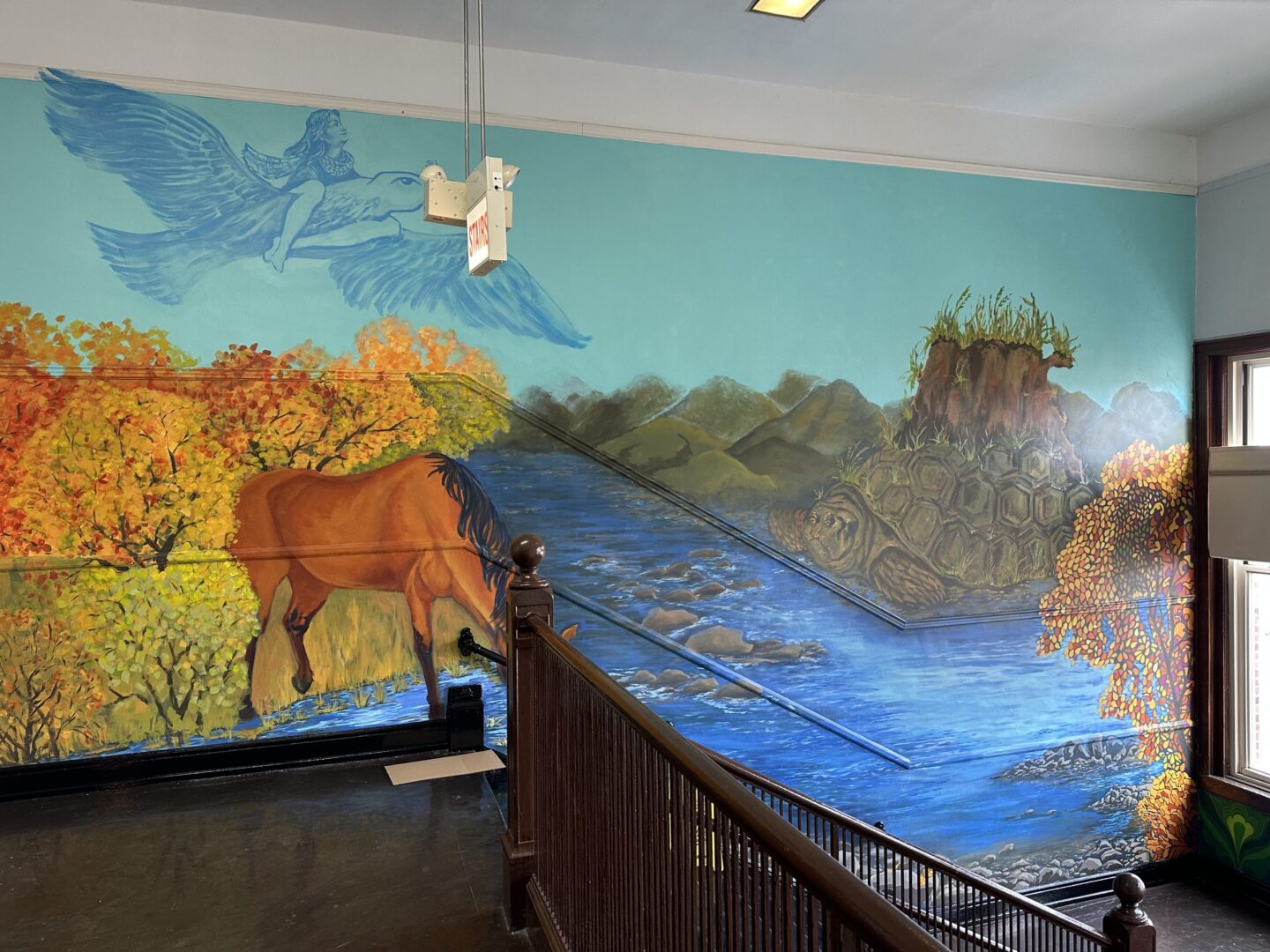 Staircase wall with a horse painting