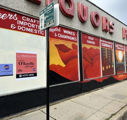 Liquor store mural with parking sign.
