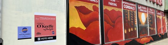 Liquor store mural with parking sign.