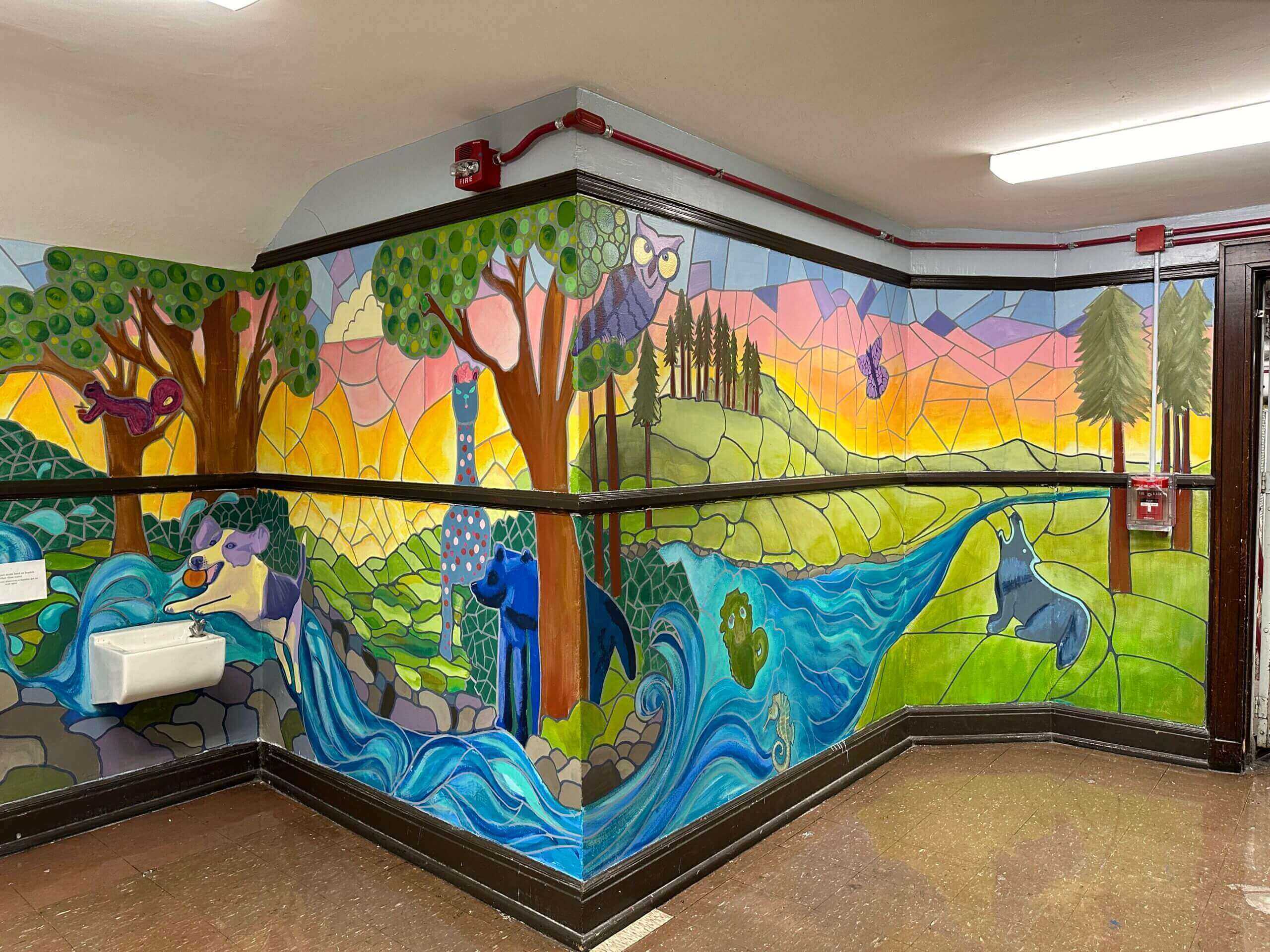 Colorful nature-themed mural in a hallway.