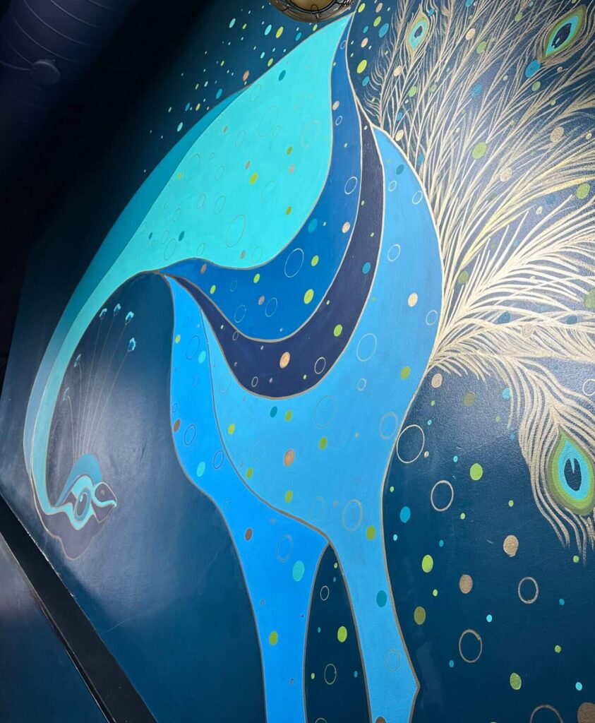 Abstract peacock mural with vibrant colors.